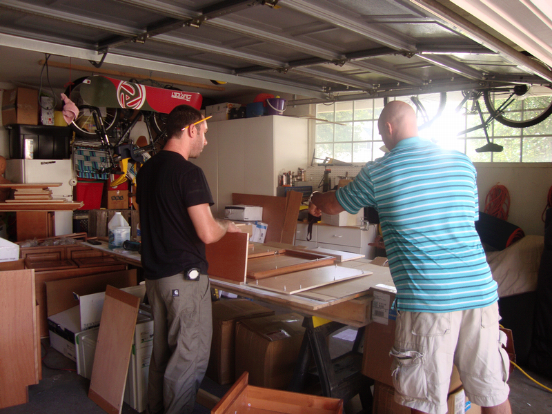 Gary showing Jake the steps for assembling a wall cabinet