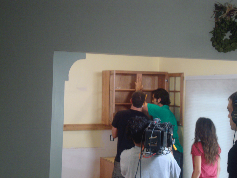 Carter Oosterhouse and Jake start installing the wall cabinets on camera